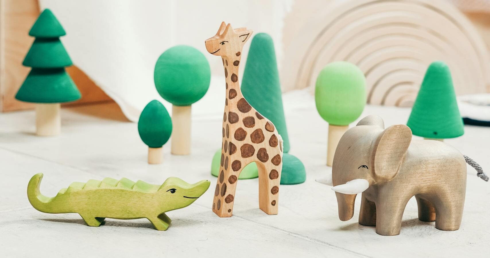Minimalist playroom with wooden animal toys, perfect for creative child engagement.